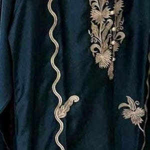 Elegant raw silk embroidered suit designed for Pakistani formal and party wear. Perfect festive and wedding outfit with fine embroidery and premium fabric, making it an ideal Pakistani formal suit or stylish party wear for women seeking timeless traditional elegance