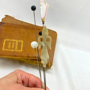 Wonderful Hat Pins Victorian Antique Set of 5 Hand Carved Mother of Pearl MOP and Glass, ca. 1900s. The longest hat pin is 10.75 in. long. They are simply lovely! Price: $72 with FREE SHIPPING at https://NothingButAntiques.etsy.com.
