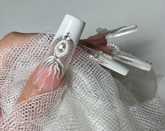 Bridal nails . White press on nail gel tips with rhinestones and decorations.