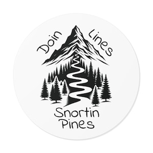 May include: A round, white sticker with a black and white mountain and forest design. The text "Doin Lines" arches above the mountain, and "Snortin Pines" is below. A winding path leads down from the mountain.