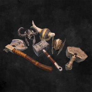 May include: A set of six fantasy-themed weapons, including a silver axe with a brown wooden handle, a silver hammer with a brown wooden handle, a silver hammer with a black handle, a silver helmet with a black and silver design, a silver helmet with a gold design, and a silver and gold decorative object.