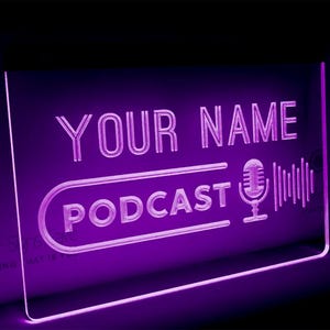 May include: Purple neon sign with the text "YOUR NAME PODCAST" and a microphone icon with sound waves.