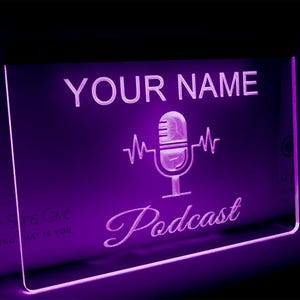 May include: Purple neon sign with the text "YOUR NAME Podcast" and a microphone icon with sound waves.