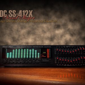 May include: A black vintage stereo analog frequency equalizer, model ADC SS-412X, with green and red lights. The device features multiple sliders and a digital display. The text "Sound Shaper" is visible on the device.