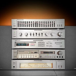 May include: A vintage silver Marantz stereo system with multiple components, including an equalizer, receiver, cassette deck, and amplifier. The system is flanked by two dark grey speakers. The components are stacked vertically.