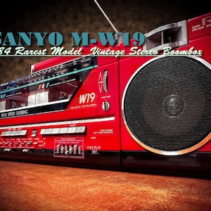 May include: A vintage Sanyo M-W19 stereo boombox from 1984. The red boombox features a large speaker, a radio dial, and cassette deck controls. The text "SANYO M-W19" and "1984 Rarest Model Vintage Stereo Boombox" are visible.