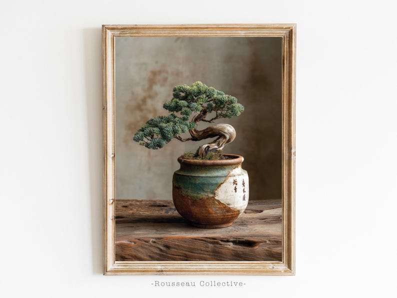 May include: Framed print of a bonsai tree in a ceramic pot. The tree has green foliage and a twisted trunk. The pot is a mix of brown, green, and white with Japanese characters. The print is set on a wooden surface.