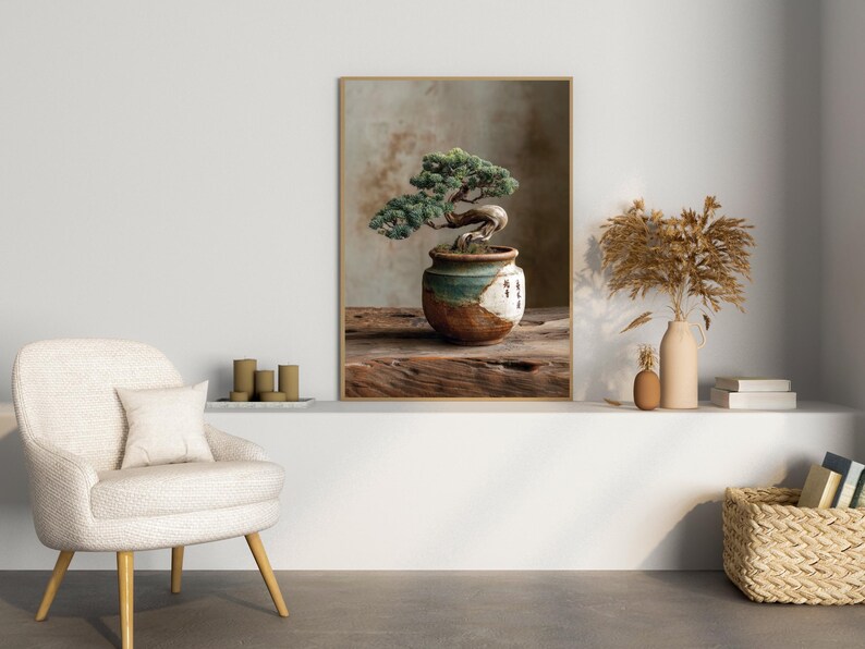 May include: A framed print featuring a bonsai tree in a decorative pot. The bonsai has green leaves and a curved trunk. The pot is brown, white, and teal. The print is displayed on a wooden surface.
