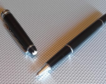 Bolígrafo roller metálico negro con anillo y clip plateados. Incluye un recambio de tinta azul Montblanc nuevo.