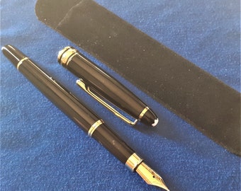 May include: A black fountain pen with gold accents and a black velvet pen case. The pen has a white star on the top.