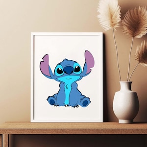 May include: A framed print featuring the character Stitch from the animated film Lilo & Stitch. The artwork depicts Stitch in shades of blue with large eyes and purple ears, set against a white background. The frame is white.