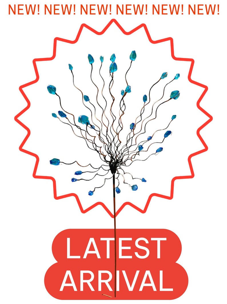May include: A decorative stem with thin, dark brown wires and blue crystal-like accents. The stem is set against a white background with a red starburst shape and the words "NEW!" repeated at the top. The words "LATEST ARRIVAL" are in a red oval at the bottom.