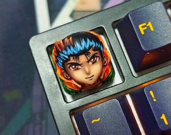 May include: A custom keycap featuring a detailed anime character portrait with orange, blue, and green accents. The keycap is installed on a dark gray mechanical keyboard, with other keys visible, including the F1 key.