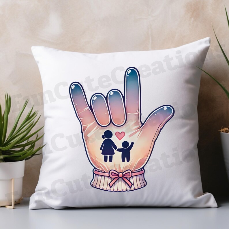 May include: White throw pillow with a colorful illustration of a hand signing 'I love you' in American Sign Language. The hand is depicted with a pink and blue gradient, and a small heart is shown between two stick figures of a woman and a child.
