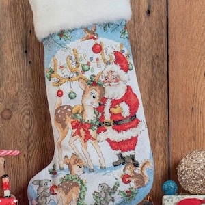 May include: Christmas stocking with a festive design featuring Santa Claus, reindeer, and woodland creatures. The stocking has a white faux fur cuff and a detailed embroidered scene with red, green, and blue accents. A charming holiday decoration.