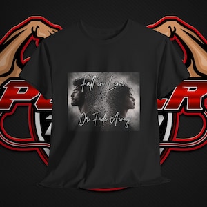 May include: A black short-sleeved t-shirt featuring a central graphic print of two profiles facing away from each other, surrounded by a particle effect. The text "Fall in Line Or Fade Away" is printed in a white script font over the image.