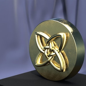 May include: A gold-colored metal disc with a four-leaf clover design. The clover is made of interwoven loops, creating a knot-like pattern.