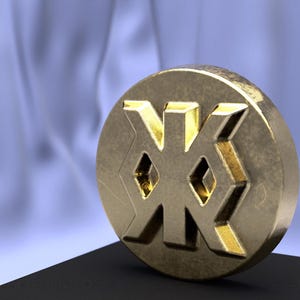 May include: A gold-coloured coin with the Cyrillic letter "Ж" embossed on it. The coin is sitting on a black surface.