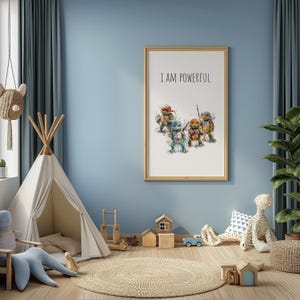 May include: A framed print with a watercolor illustration of the Teenage Mutant Ninja Turtles. The print has the text "I AM POWERFUL" at the top. The print is hanging on a light blue wall in a child's room.