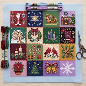 May include: A square needlepoint canvas featuring a sixteen-panel grid of Christmas motifs including Santa, a sleigh, a fireplace, a wreath, candles, candy canes, cardinals, a poinsettia, a tree, and bells, with embroidery floss and scissors.