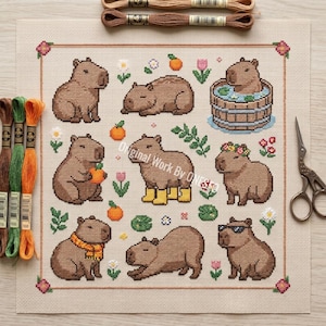 May include: Cross-stitch pattern featuring nine brown capybaras in various poses, some with accessories like sunglasses and boots. The design includes flowers, oranges, and greenery on a beige background. Embroidery floss and scissors are also visible.
