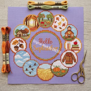 May include: A cross-stitch project on a lavender background features a circular design with autumn-themed illustrations. The words "Hello September" are in the center. Embroidery floss in shades of orange, yellow, and green are at the top and left. A pair of gold scissors is on the right.