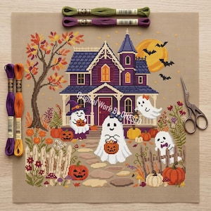May include: A cross-stitch pattern on beige fabric featuring a purple haunted house, a yellow moon, bats, and three ghosts holding jack-o'-lanterns. The scene includes a tree with autumn leaves, pumpkins, flowers, and a fence. Embroidery floss and scissors are included.