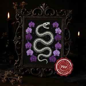 May include: Cross-stitch pattern featuring a white snake skeleton design on a black background, framed by purple orchids. The framed artwork is in a dark, ornate frame. A red PDF stamp is in the lower right corner.