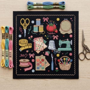 May include: A black cross-stitch fabric piece featuring colorful sewing motifs including scissors, spools of thread, a pincushion, a sewing machine, a measuring tape, and buttons, with the text Original Work By ONESEO, surrounded by embroidery floss.