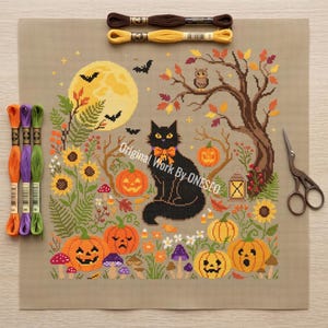 May include: A cross-stitch pattern on beige fabric featuring a black cat with an orange bow, surrounded by pumpkins, sunflowers, mushrooms, a tree, and a full moon. The text Original Work By ONESEO is visible. Includes three embroidery floss skeins and scissors.