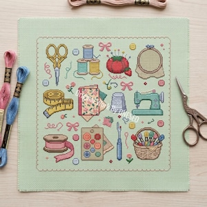 May include: A light green cross-stitch fabric featuring a grid of sewing motifs including gold scissors, colorful thread spools, a red tomato pincushion, a measuring tape, a sewing machine, a thimble, buttons, and a basket of embroidery floss.