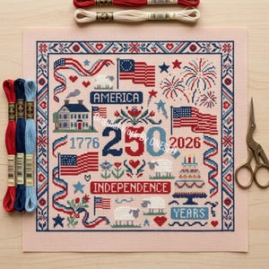 May include: A cross-stitch project celebrating the 250th anniversary of American Independence. The design features American flags, fireworks, a house, sheep, and the words "America," "Independence," and "Years." Embroidery floss and scissors are also visible.