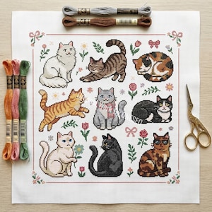 May include: A cross-stitch pattern featuring nine different cat designs in various poses and colors, surrounded by floral and bow motifs. Embroidery floss and scissors are also visible, suggesting a crafting project.