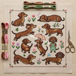 Op de afbeelding: Een kruissteekpatroon met meerdere teckels in verschillende poses, omringd door bloemen. De honden zijn bruin met bruine aftekeningen. Borduurgaren in bruin, groen en roze, en een gouden schaar zijn ook inbegrepen.