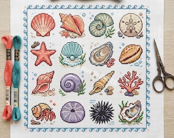 May include: A square cross-stitch pattern on white fabric featuring a grid of sixteen marine life illustrations including various seashells, a starfish, a sand dollar, coral, and a sea urchin, framed by a blue wave border with embroidery floss and scissors.