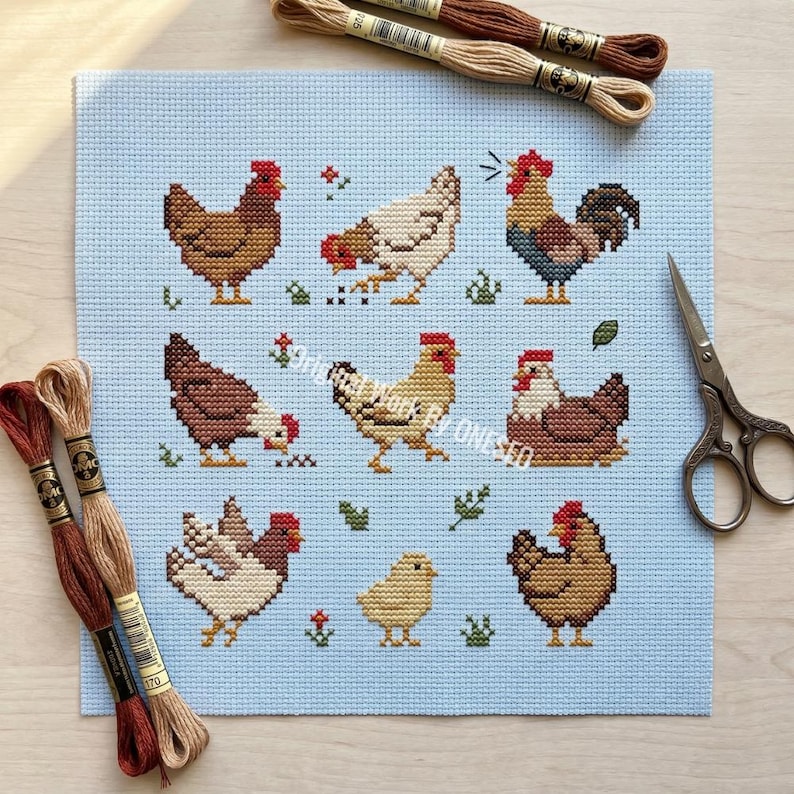 May include: A cross-stitch pattern featuring various chickens and a chick on a light blue background. The chickens are in shades of brown, white, and tan, with red combs. Embroidery floss and scissors are also visible. The artwork is a handmade craft project.