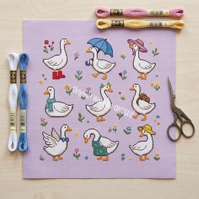 May include: A cross-stitch pattern featuring nine whimsical geese, each adorned with unique accessories like boots, hats, and umbrellas, set against a lavender background. Embroidery floss and scissors are also visible. The text "Original Work by ONESEO" is also visible.