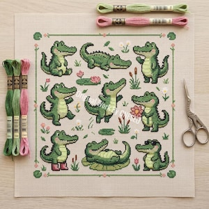 May include: A cross-stitch design with green alligators in different poses, set amongst flowers and foliage. The image includes embroidery threads in green and pink, plus a pair of scissors. The text "Original Work By CNESEO" is visible.