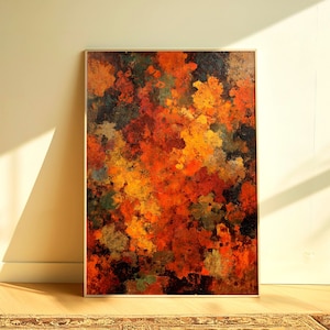 Op de afbeelding: Abstracte kunstprint met een warm kleurenpalet. Het kunstwerk toont een mix van oranje, rode, gele en groene tinten, waardoor een textuurrijk, schilderachtig effect ontstaat. Het ingelijste stuk wordt tentoongesteld tegen een neutrale muur, met een schaduw.