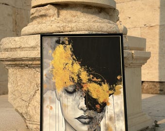 May include: A framed abstract painting of a woman's face with gold and black paint splatters. The woman's eyes are closed and her mouth is slightly open. The background is a light grey colour.