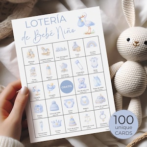 May include: A baby shower game card with the title "LOTERÍA de Bebé Niño" in blue script. The card features illustrations of baby-related items like a crib, toy car, and pacifier. A round sticker on the right says "100 unique CARDS".