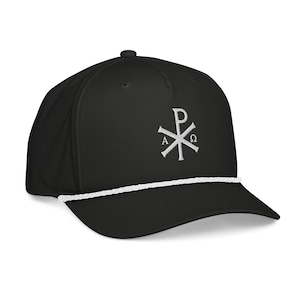 May include: Black baseball cap with a white rope detail and a white embroidered Chi Rho symbol. The cap has a curved brim and a button on top. A stylish accessory for everyday wear.