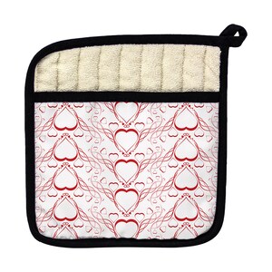 May include: A white pot holder with a black border and a red heart pattern. The hearts are outlined in a thin, red, swirling design.