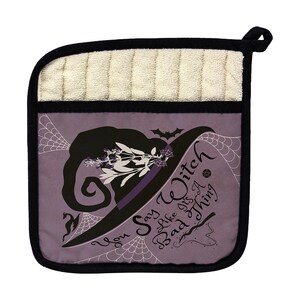 May include: A purple and black pot holder with a witch hat design and the text "You Say Witch Like It's A Bad Thing". The pot holder has a cream-colored terry cloth pocket and a black hanging loop.