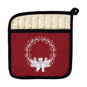 May include: Red pot holder with a white wreath design featuring a candle and a bow. The pot holder has a beige quilted lining.