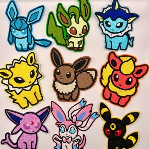 May include: Nine embroidered patches featuring various cartoon creatures in vibrant colors. The patches include characters in shades of blue, green, yellow, brown, red, pink, and black, each with unique designs and details. These patches are likely for clothing or accessories.