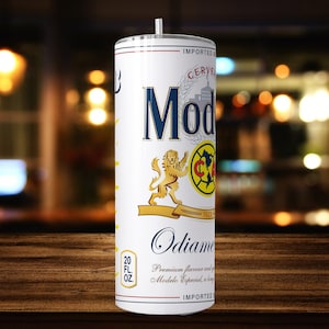 May include: White 20 fl oz. stainless steel tumbler with a design of a Modelo Especial beer can. The design features a lion, a soccer ball, and the text "Modelo Especial" and "Cerveza Modelo".
