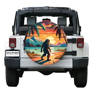 Bigfoot on beach sunset palm trees yeti spare tire cover available with camera hole