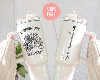 May include: Two white insulated tumblers. One features the text "Respiratory Therapist" with a lung and floral design. The other has the name "Samantha" in script with a heart. Both have white handles and lids.