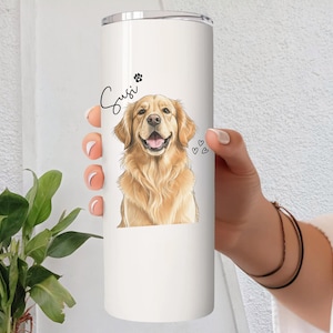May include: A white stainless steel tumbler featuring a golden retriever illustration. The dog's name, "Susi", is written in cursive above the image, along with a paw print and three small hearts.